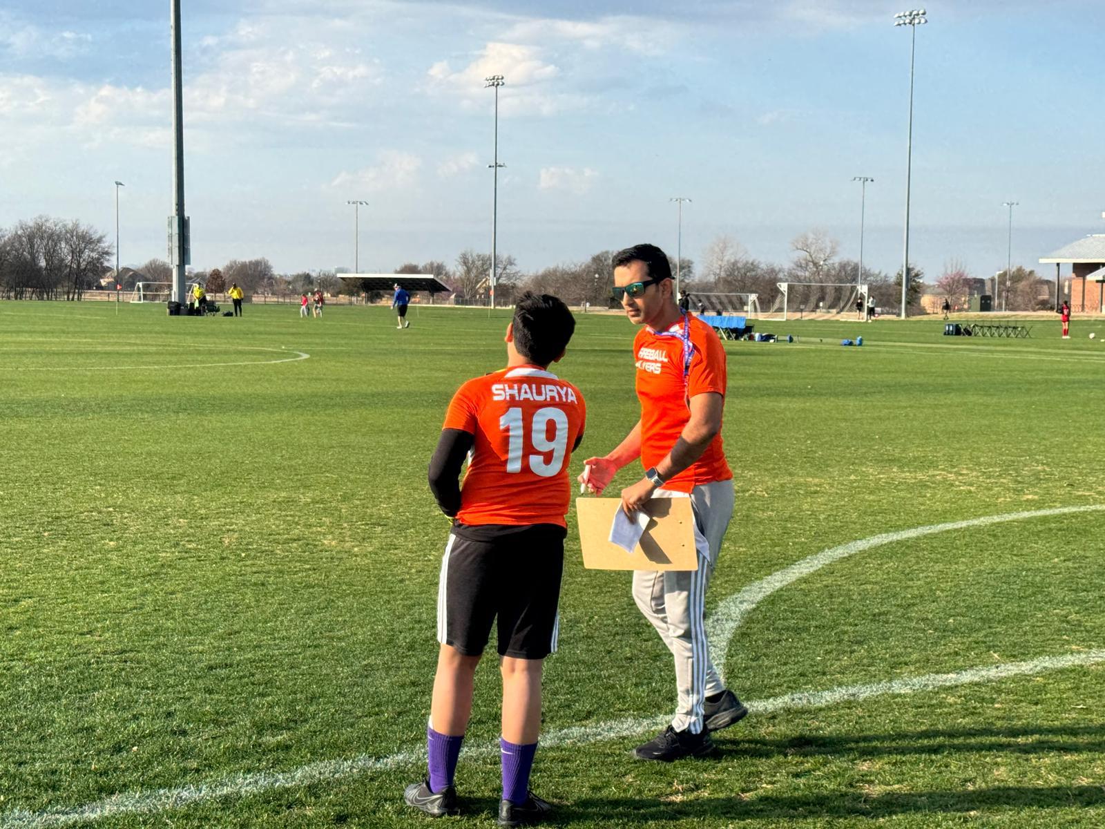 Coach talking to a young goalkeeper before the game