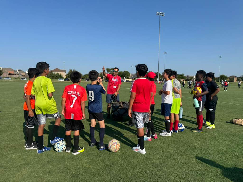 Coach explaining strategy to players with a whiteboard
