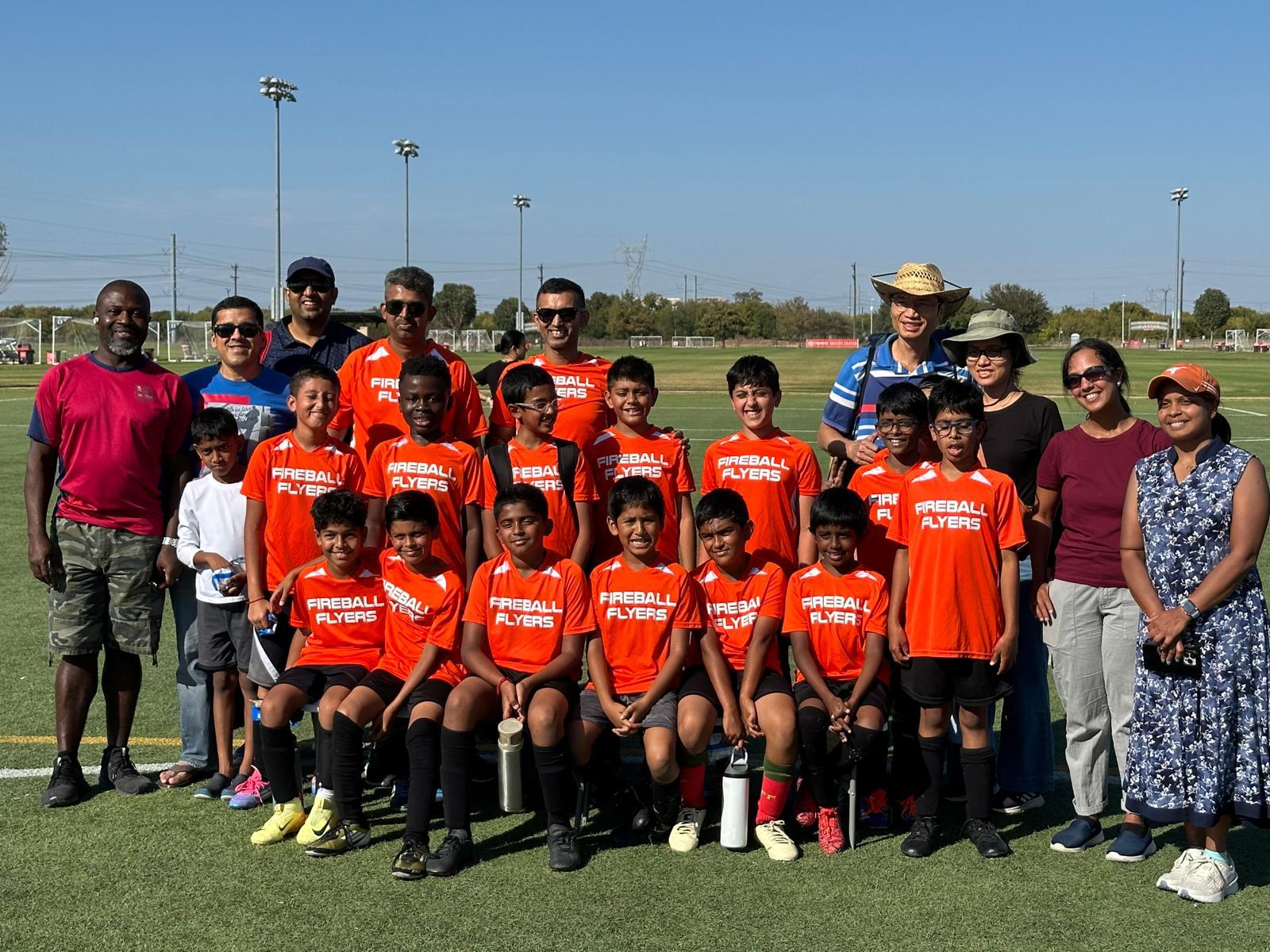 Parents, players and coach celebrating after a game